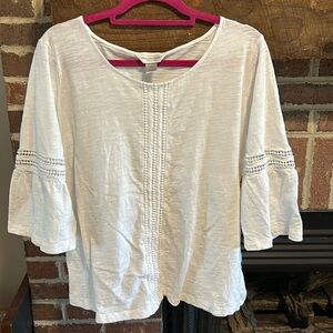 White blouse with bell sleeves.